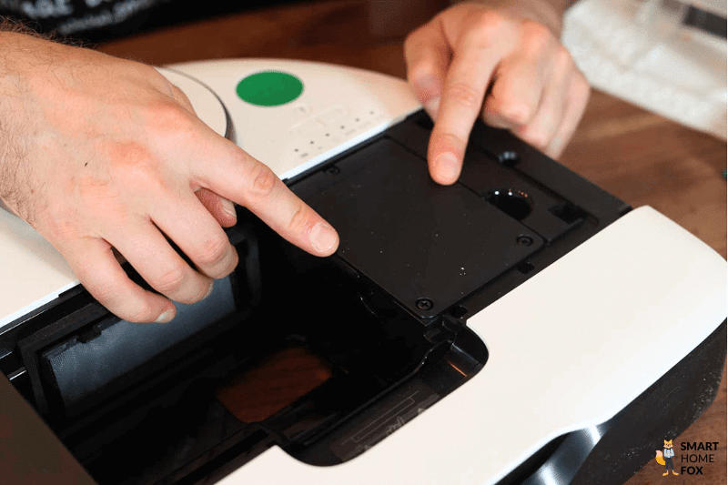 Ein Finger zeigt auf den austauschbaren Akku des Vorwerk Kobold VR7